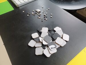 Laser cut playing pieces for 110, from recycled corrugated card
