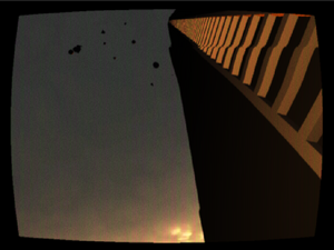 A screenshot from the game 2.22am showing a dark gloomy landscape with a low-poly rendered building towering over you.