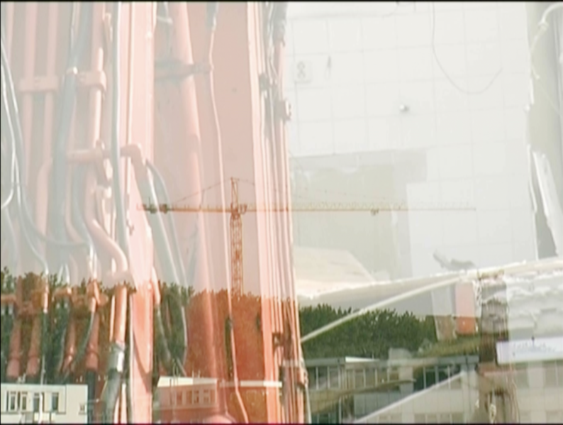 File:Still image of earlier video work about constructing and demolition in Rotterdam, we see demolition of tweebos buurt with cranes buiilding the New Rijnhaven boulevard.png