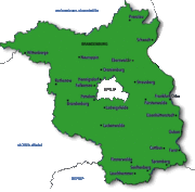 A green area highlighted on a white map. dark blue dots indicate names of cities.