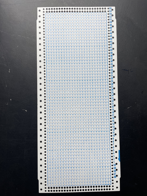 Punch card for the knitting machine, it is unused and has a printed grid (24x60 squares))